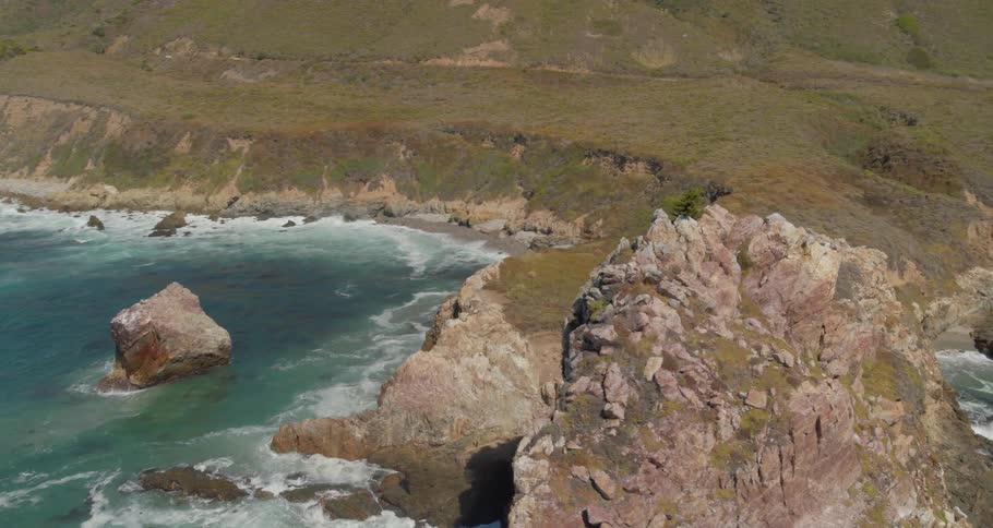 Scenic coastal view of waves crashing in coves near the cliffs