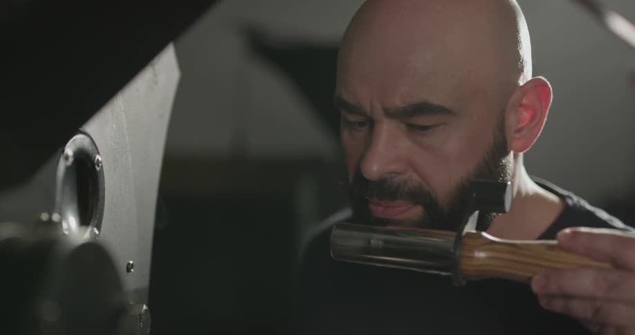 Man operating a machine and smelling one component