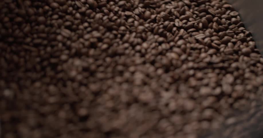 Coffee beans tumbling in a mixing machine