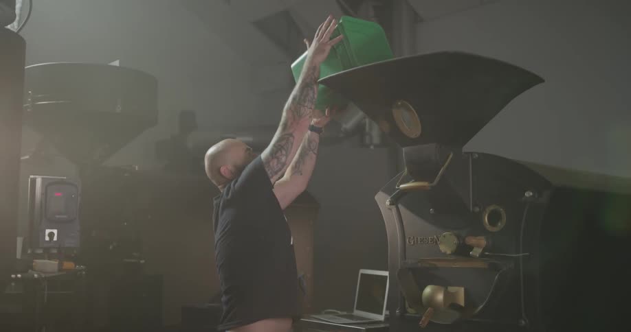 A man pours beans into a coffee machine