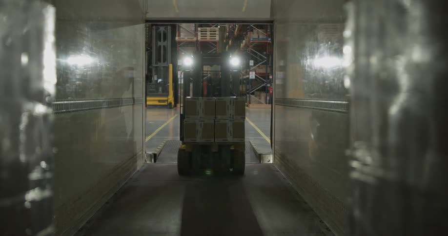Forklift loading boxes into truck