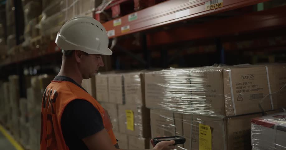 A man scans boxes