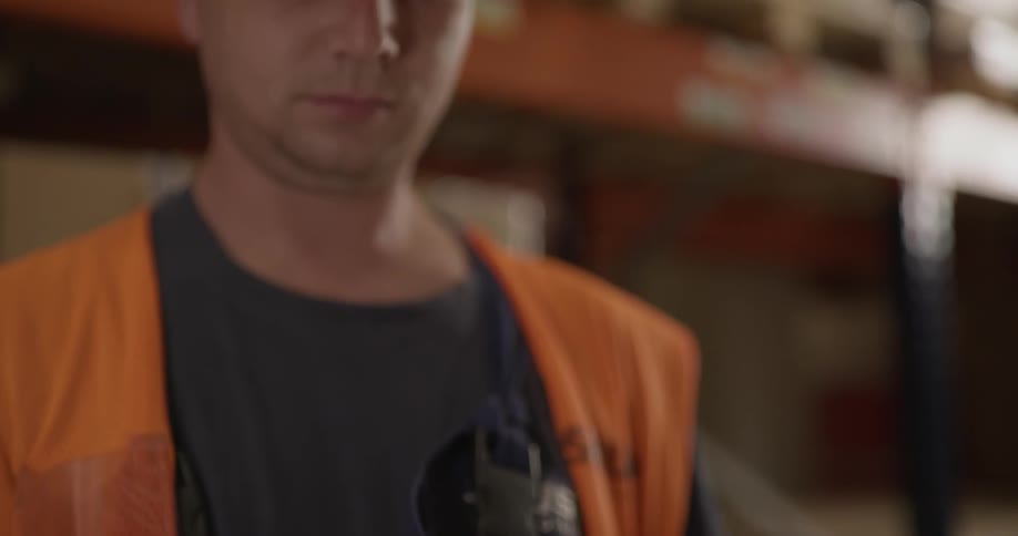 A man types something in to a handheld scanner