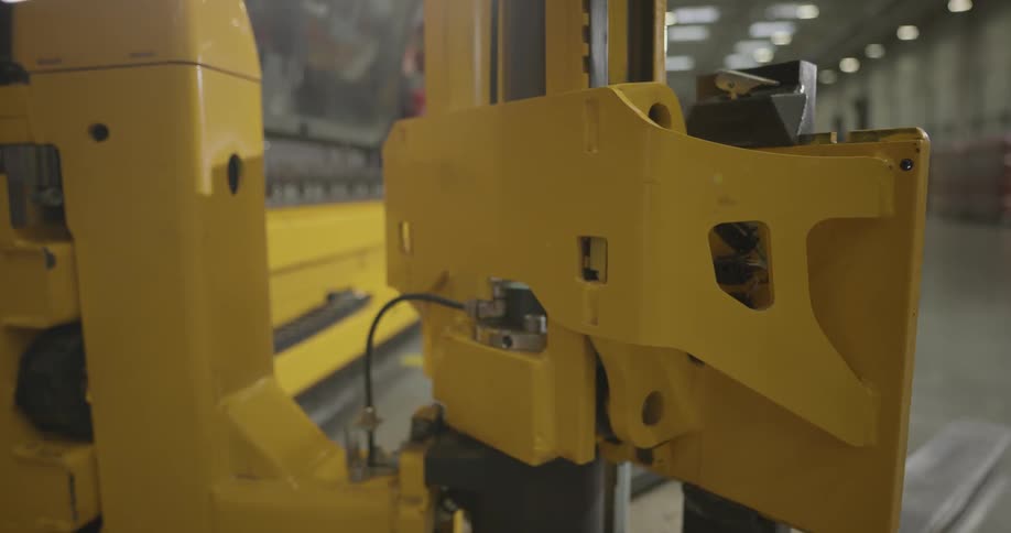 A yellow forklift turning to the left