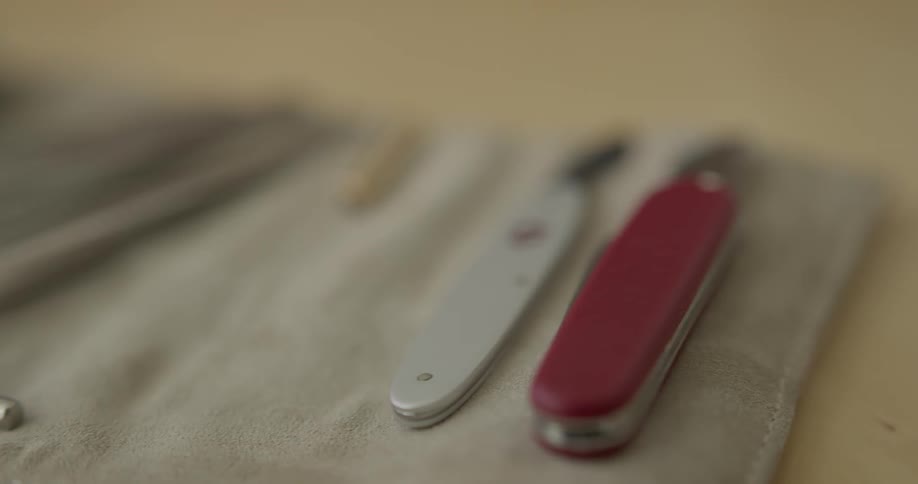 Tools are laid out and a person picks one up