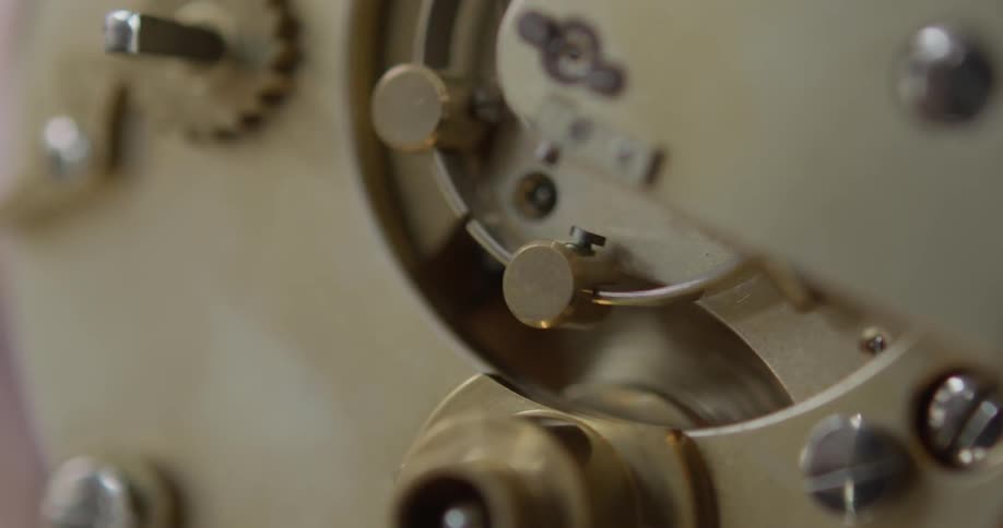 Gears in a clock rotating back and forth