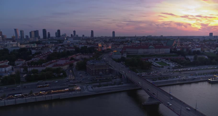Skyline of the city with cars driving on the road at dusk