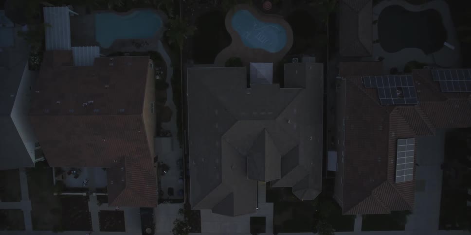 An aerial view of large homes at dusk