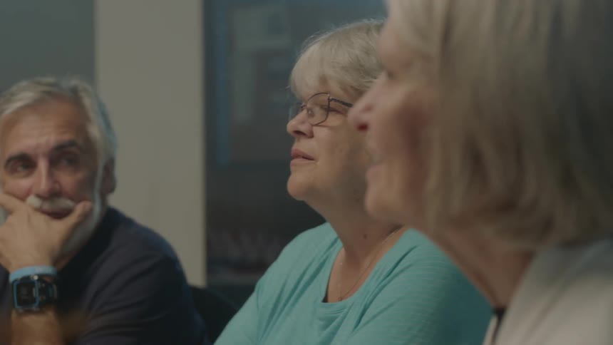 Two women and a man sitting and talking