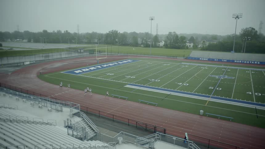 People running around a track at a stadium