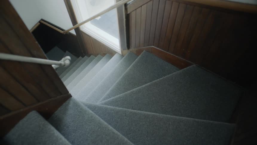 The sun shines in the window on the staircase