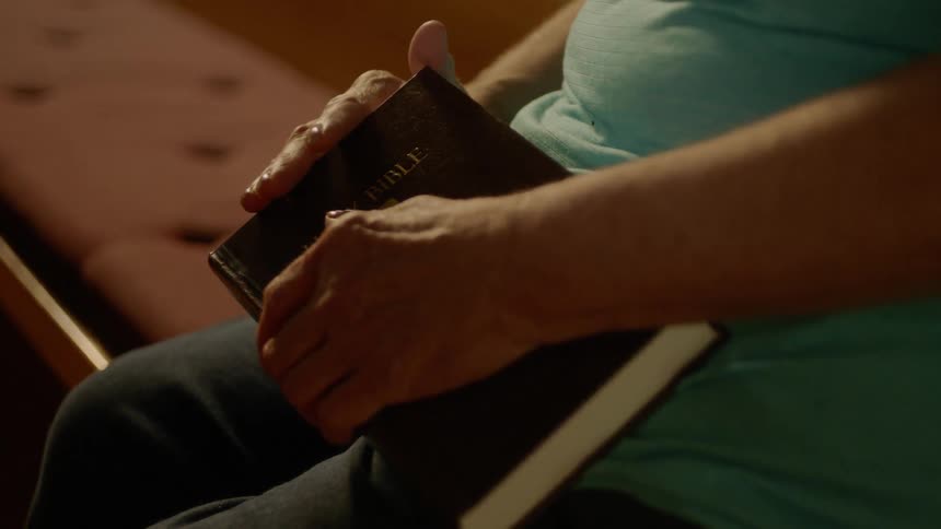A person holds a bible