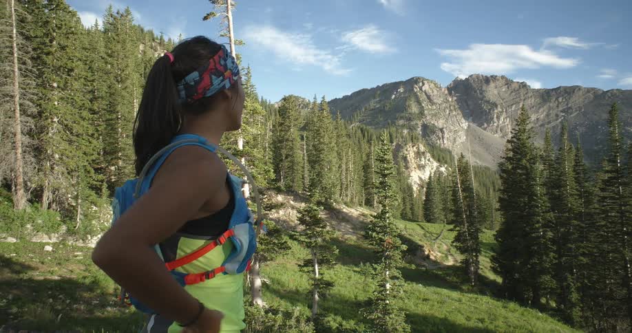 A woman is hiking on a sunny day