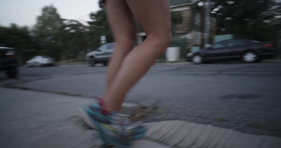 A person walks across the street during the day