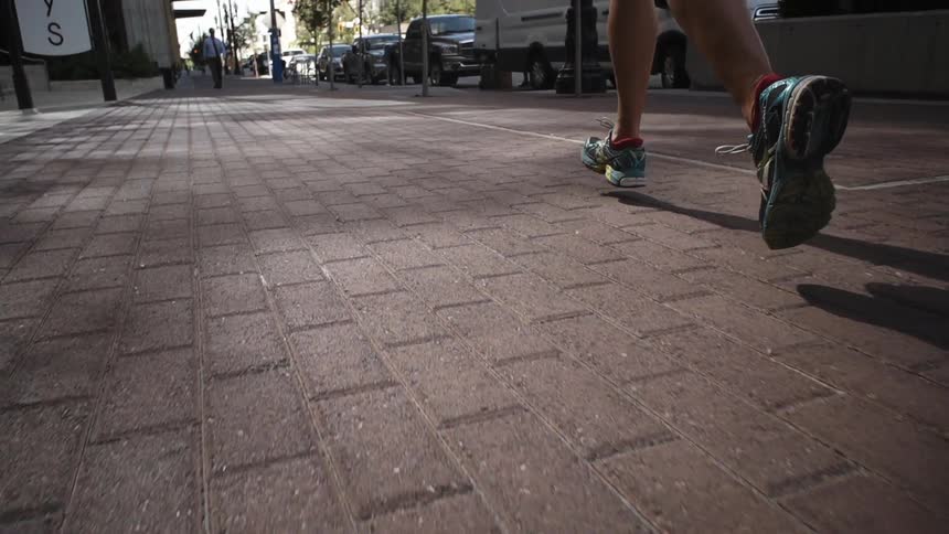 Someone running over a brick path