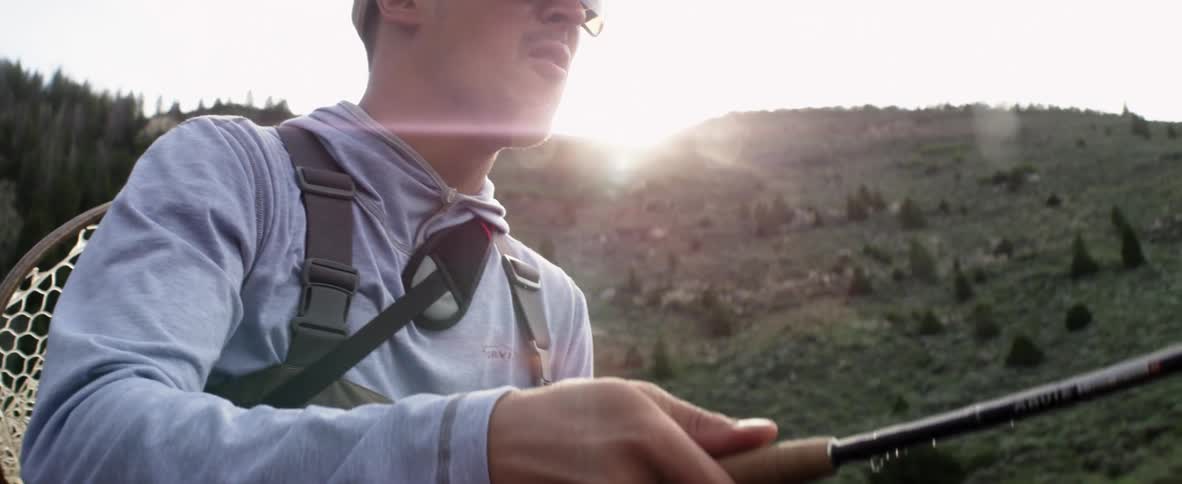 A man holding a fishing rod in his hands