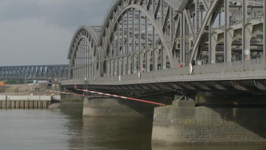 A person bikes across a bridge