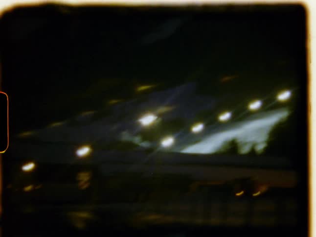A car is driving at nighttime