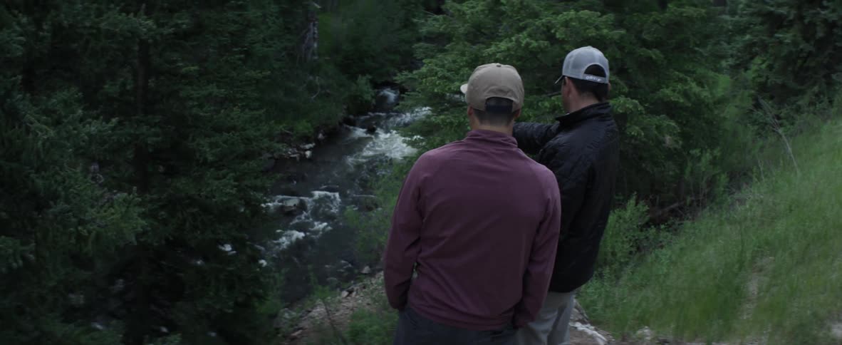 Men pointing at a river