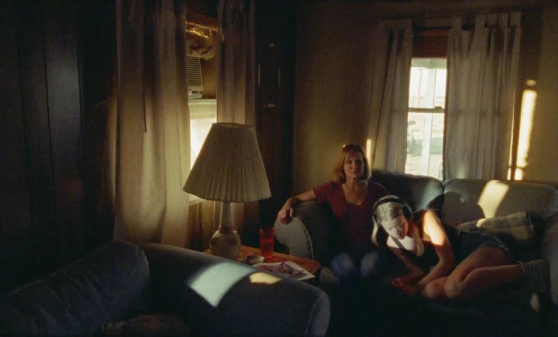 Two people are sitting on a couch together