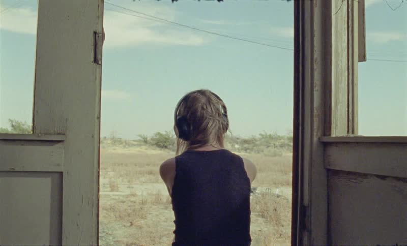 A woman sitting with headphones on