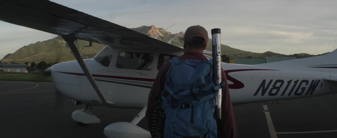 A person walking towards a plane