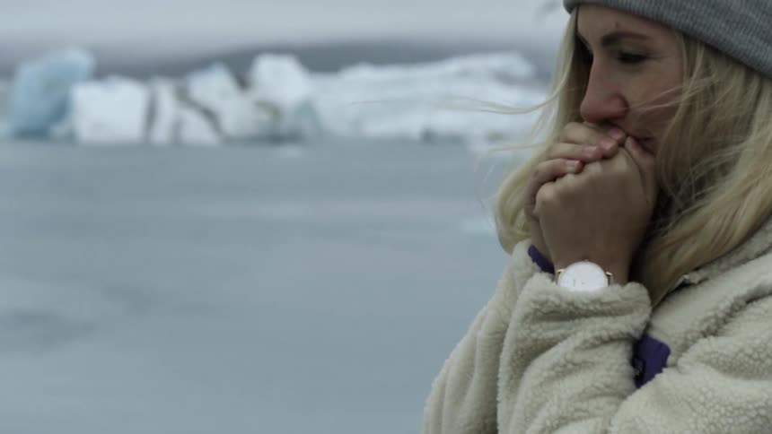 A person holding their hands to their mouth