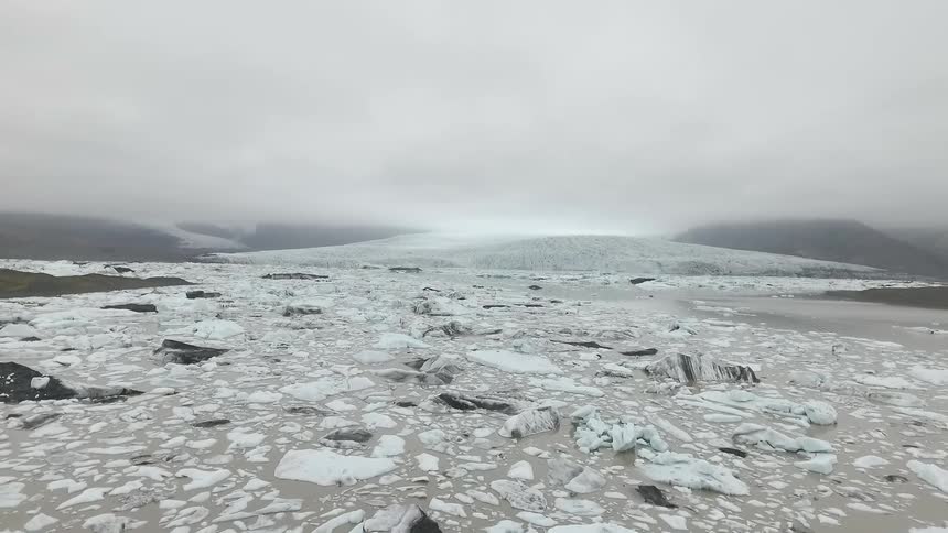 A rocky and snowy mountain plateau on a cloudy day