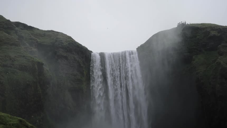 Waterfall running over mountain side