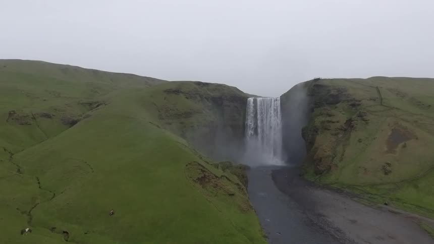 A waterfall cascades over a cliff