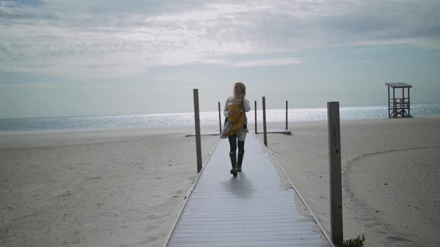 A person walking down a pier