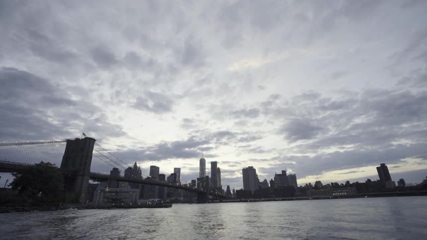 View of a city beyond some water on a cloudy day