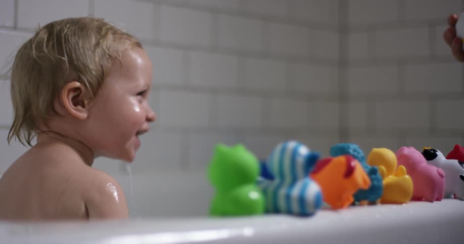 A child playing in a bathtub