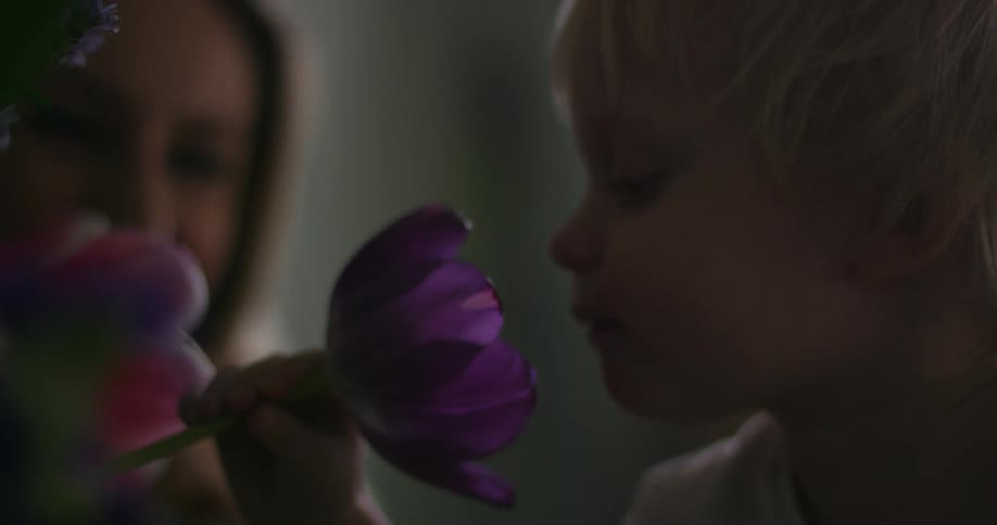 A child smelling fresh flowers