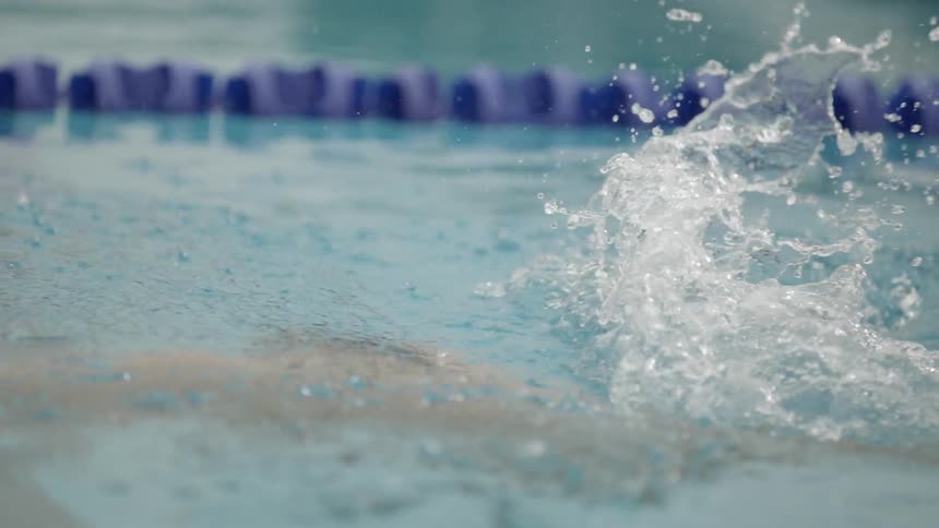A man is swimming in a pool