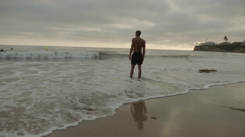 A man stands on the beach