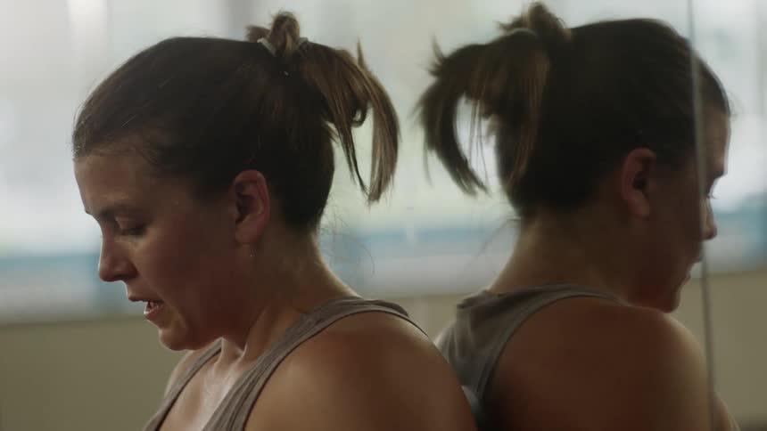 A female dancer contemplating at the studio