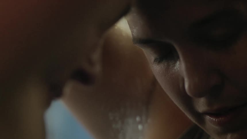 A sweaty woman resting against a mirror