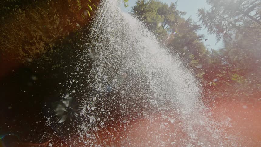 Water is falling from a waterfall outdoors