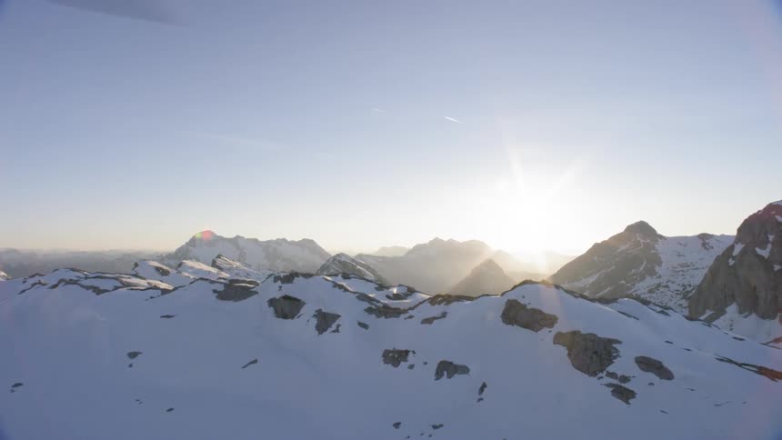 An aerial view of a snowy mountain ridge taken from a helicopter