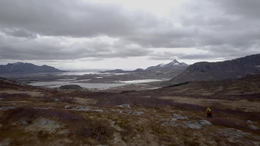 Clouds float over a lake and mountains in the wilderness