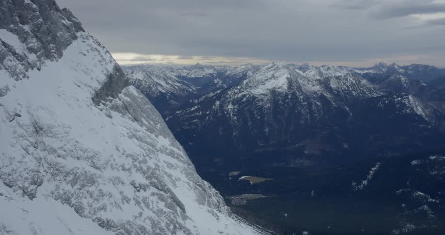 A valley between two snowy mountain ridges