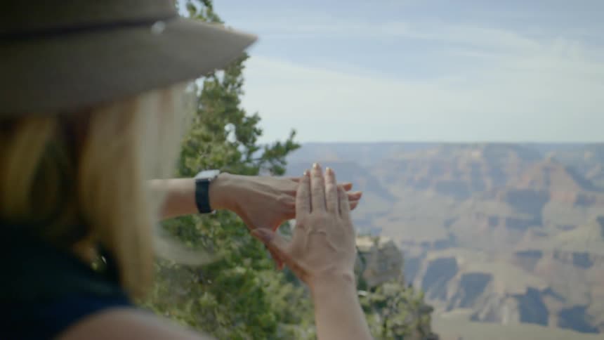 A woman is looking out over the canyon