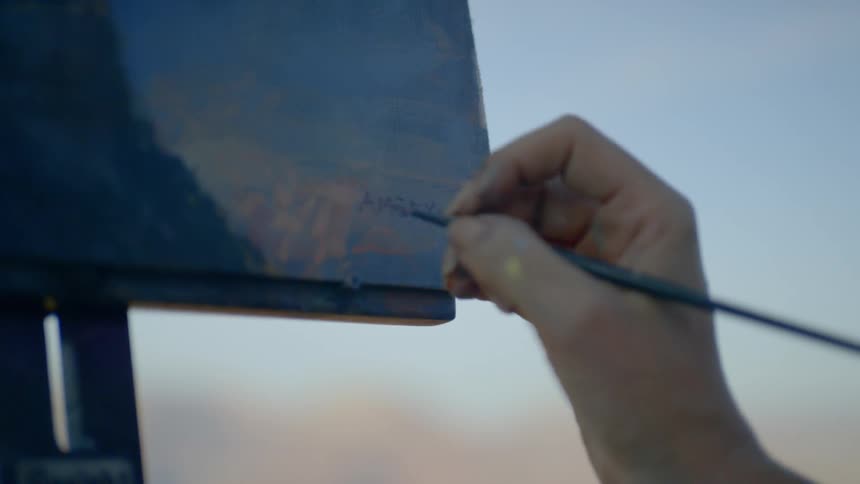 A painter painting a landscape