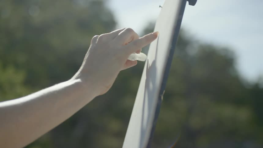 A person is drawing on a canvas with paint