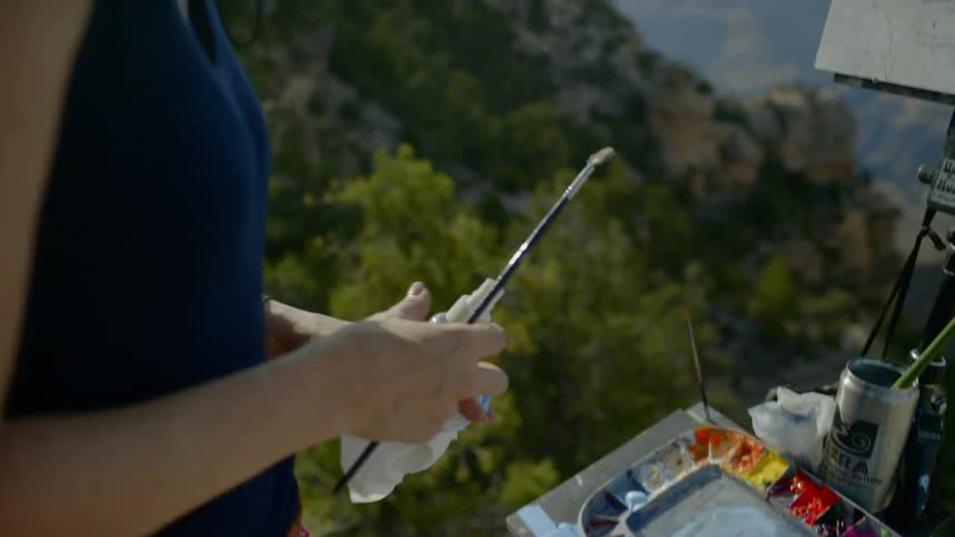 A painter painting at the mountain