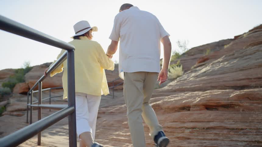 Two people walk down the rail