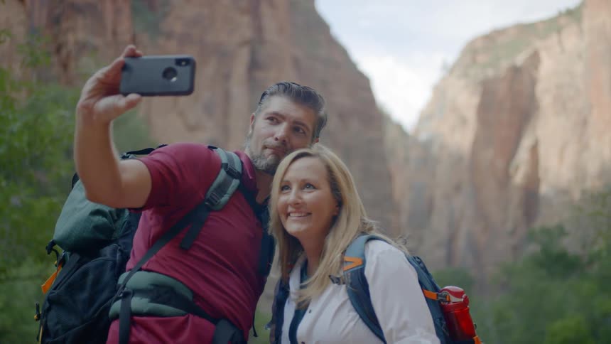 Man and woman take a selfie in the canyons during daylight