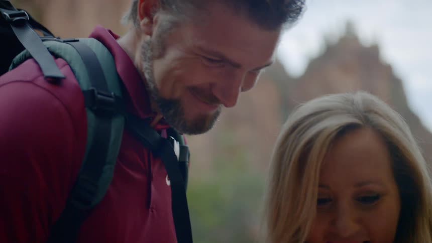 A man and a woman looking at a smartphone