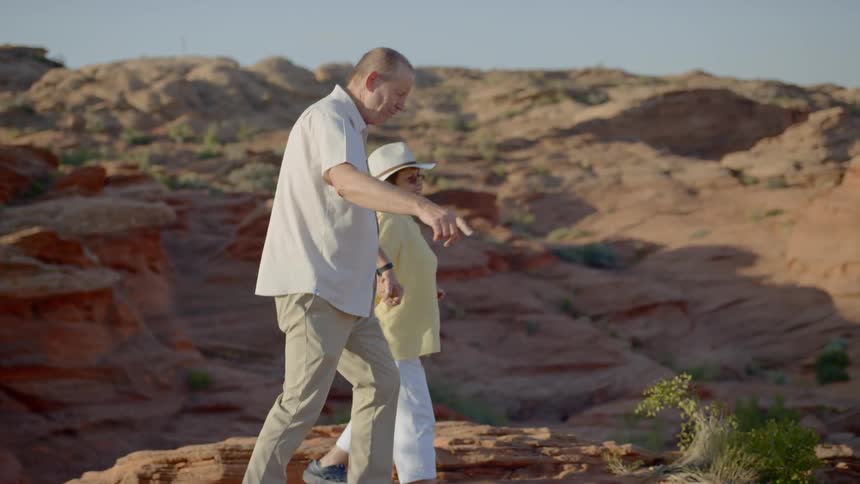 An old couple walking at the canyon